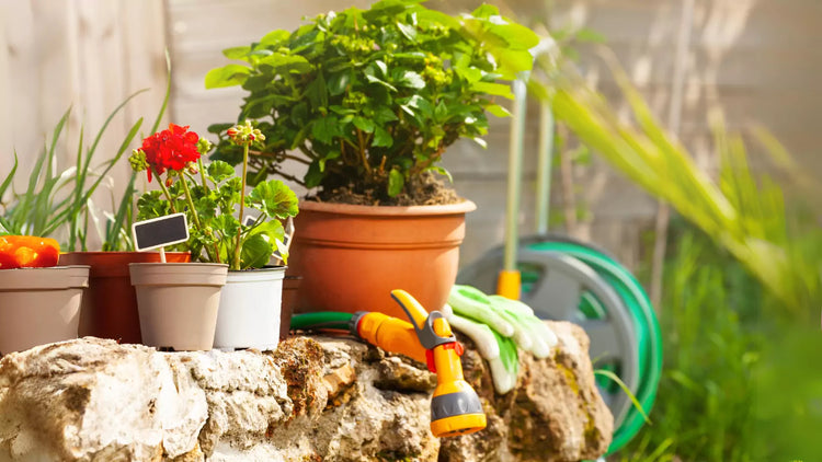 various gardening tools from Sweorn Store on a rock in front of a wooden fence