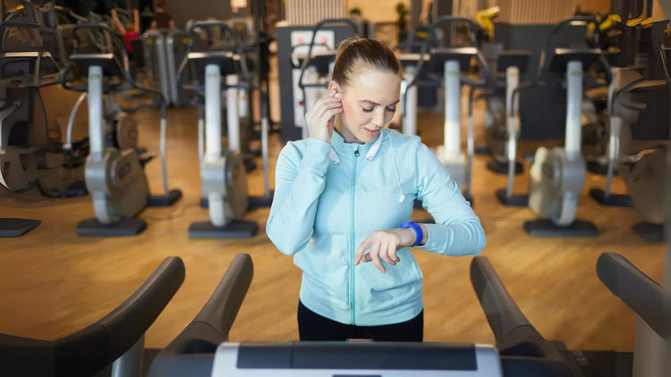 A person on a treadmill looking at their phone