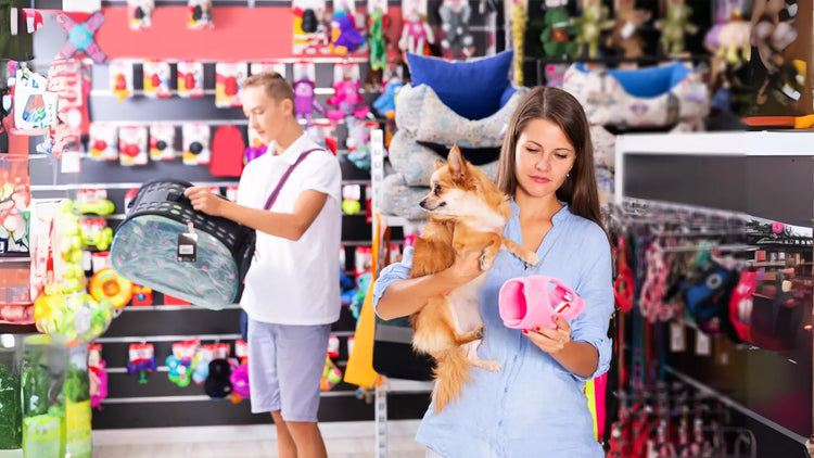 A person holding a small dog in a pet store